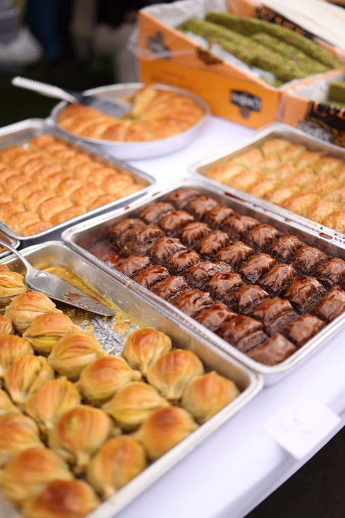 Tempting display of various pastries and baklava on trays, perfect for food photography lovers.